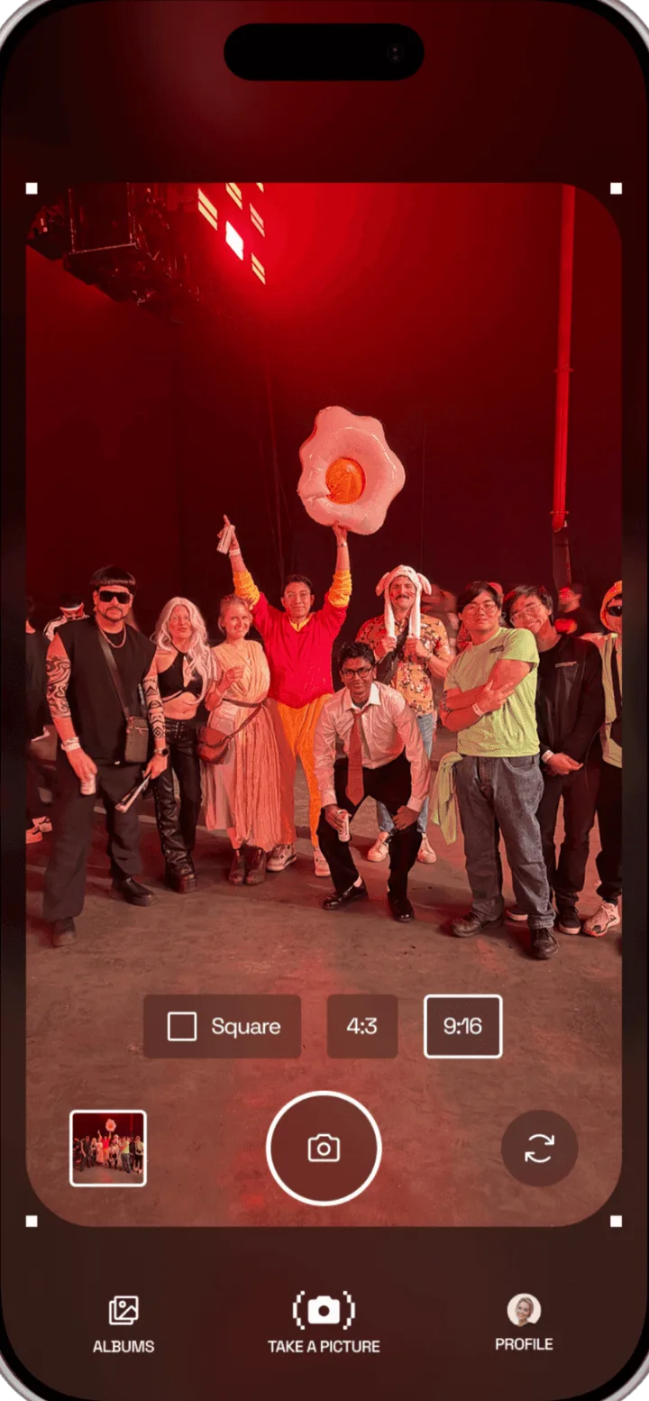 Plurr camera framing a crowd under red stage lights, with the shutter, last-shot preview and format options